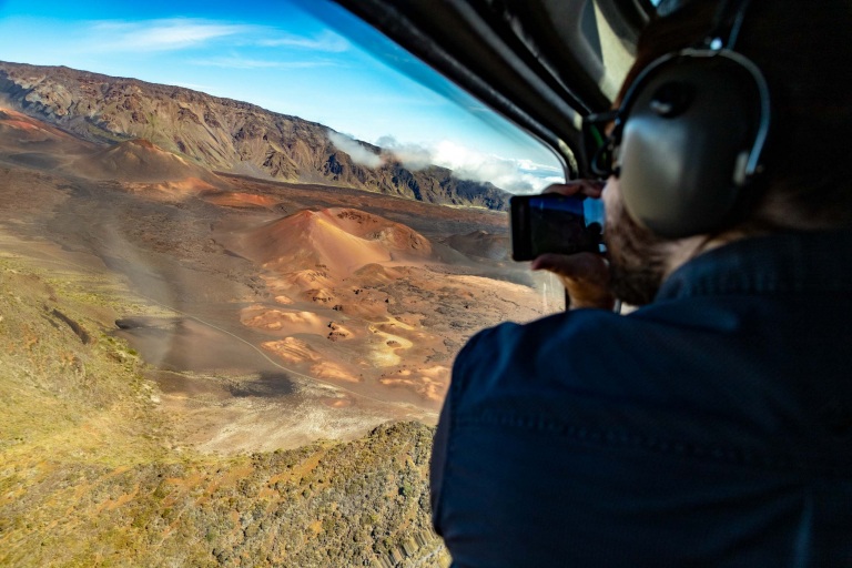 A guest views the cinder cones inside of Haleakala crater from a helicopter