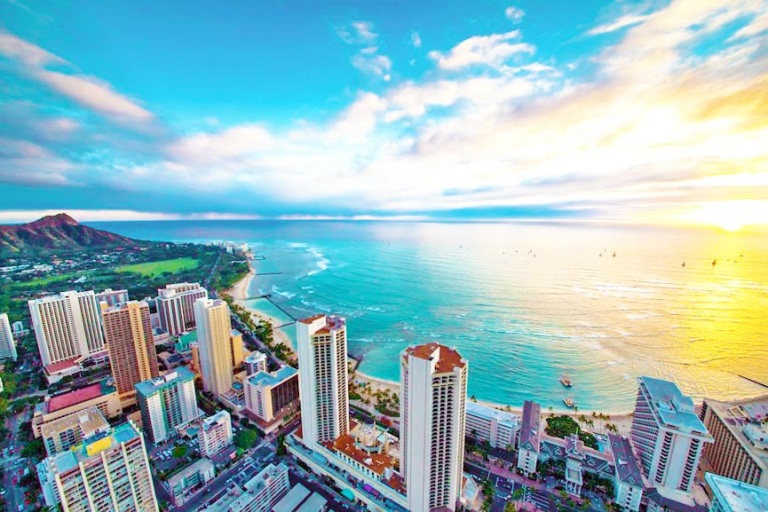 view the city horizon as it basks in the warm evening light oahu rainbow helicopters
