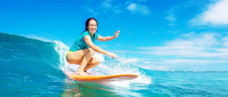 beautiful girl surfing on big transparent waves maui island banner
